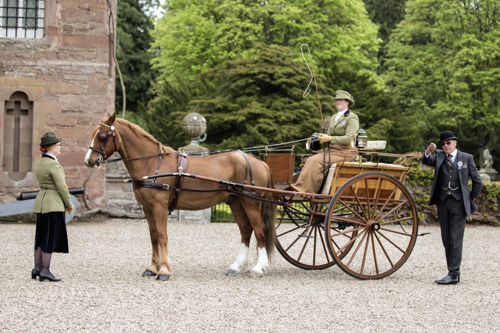 Elinor Bosanquet driving a Manchester Cart belonging to Ewan MacInnes at Gordon Marks' judging area by the Castle